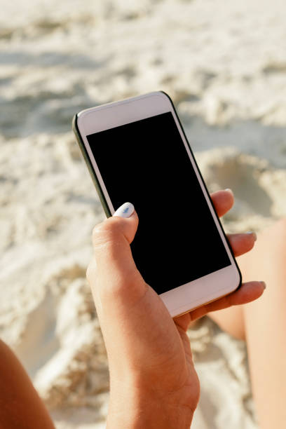istock Female hand holding smartphone with blank screen close up 921915664