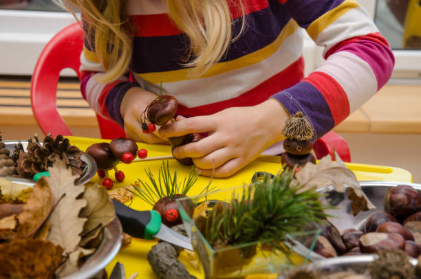 istock child making chestnut figures from autumn chestnuts 921915854