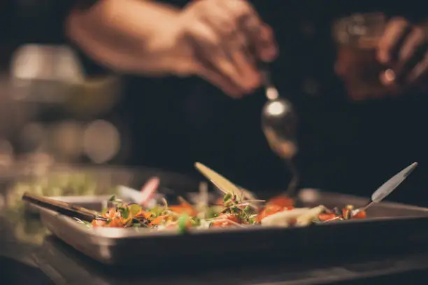 Chef preparing food in a commercial kitchen. Caterer, food service concept