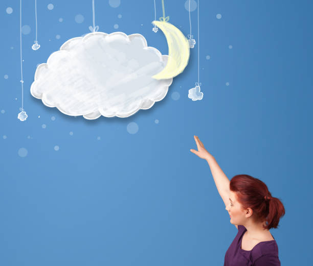istock Young girl looking at cartoon night clouds with moon 921917020