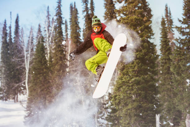 istock Snowboarder jumps at offpiste slope 921920758