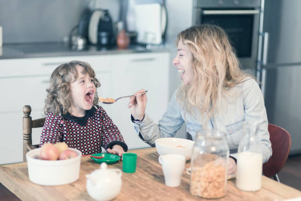 istock Mother and son having breakfast in the kitchen at home 921923600