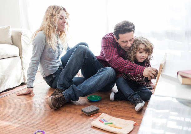 istock Parents with child drawing on blackboard at home 921923622