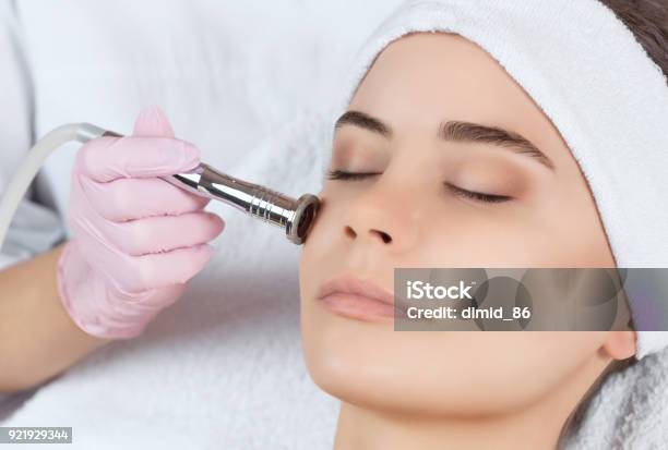 The Cosmetologist Makes The Procedure Microdermabrasion Of The Facial Skin Of A Beautiful Young Woman In A Beauty Salon Stock Photo - Download Image Now