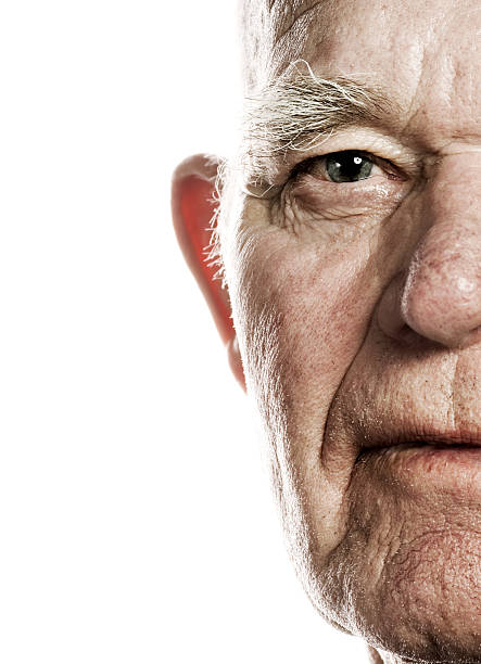 Elderly man's face over white background stock photo