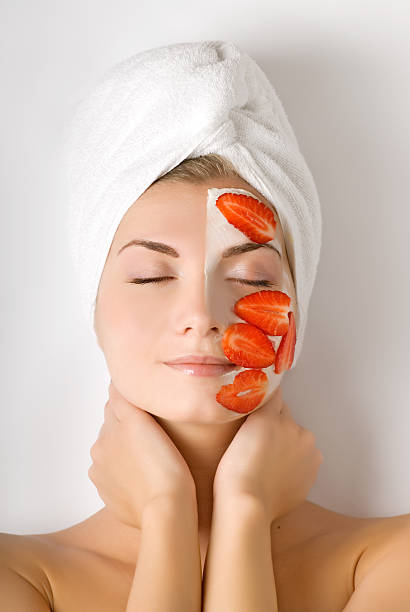 Beautiful woman with fruit mask on her face stock photo