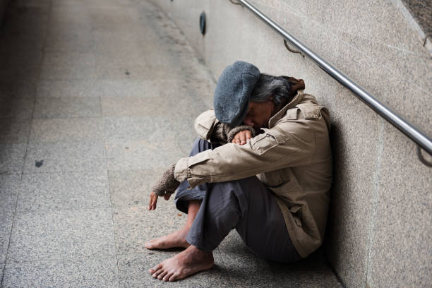 istock Old beggar or Homeless man in town 921935128