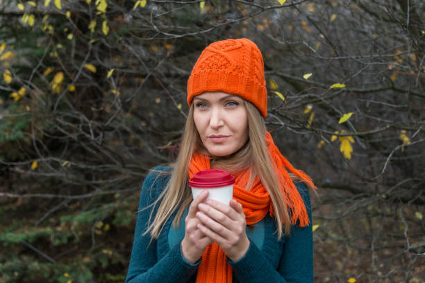 istock Woman holding a cup 921935434