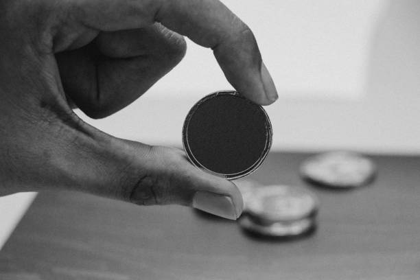 istock Man's hand holding golden coin 921935444