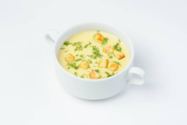 istock Cheese cream soup with croutons and fresh herbs on a white background 921938600