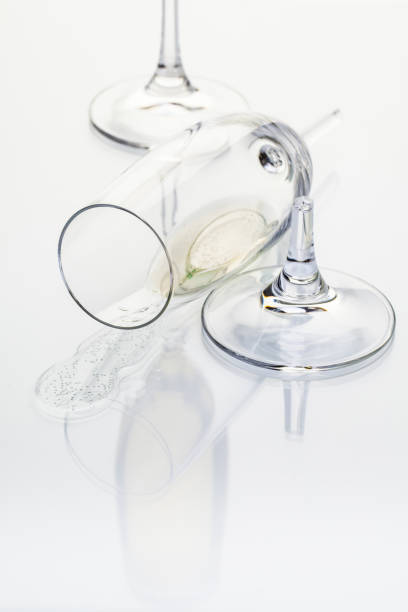istock broken glass of champagne on white table 921942510