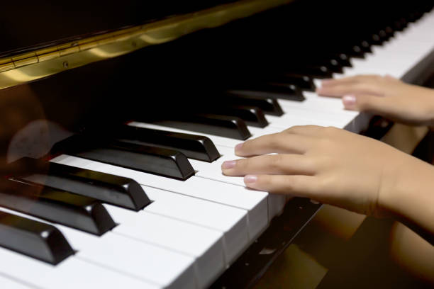 istock hands of kid playing piano 921950568