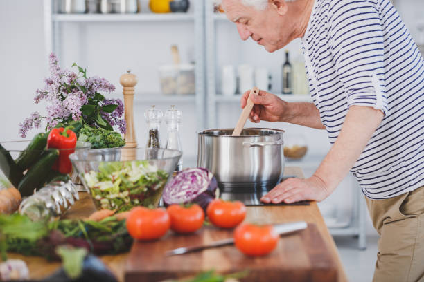 Elderly man smelling tomatoe soup