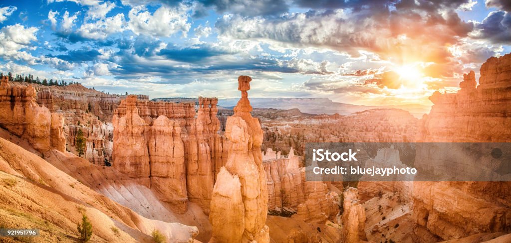 Bryce Canyon National Park at sunrise with dramatic sky, Utah, USA Panoramic view of amazing hoodoos sandstone formations in scenic Bryce Canyon National Park in beautiful golden morning light at sunrise with dramatic sky and blue sky, Utah, USA Bryce Canyon National Park Stock Photo