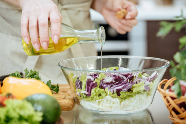 istock Pouring olive oil on freshly made salad. 921952086