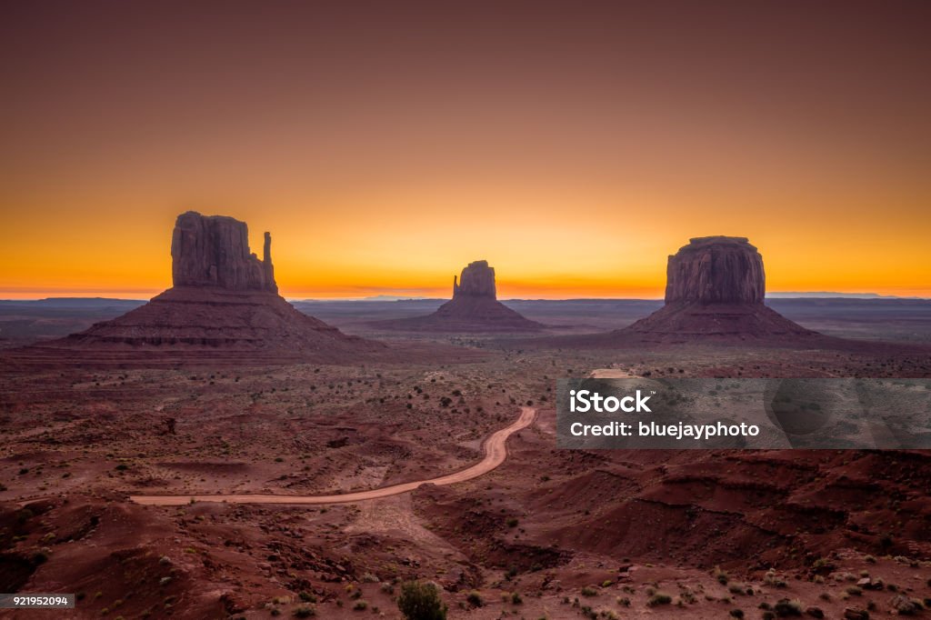 Monument Valley at sunrise, Arizona, USA Classic view of scenic Monument Valley with the famous Mittens and Merrick Butte in beautiful golden morning light at sunrise in summer with retro vintage Instagram style filter effect, Arizona, USA Grand Canyon Stock Photo