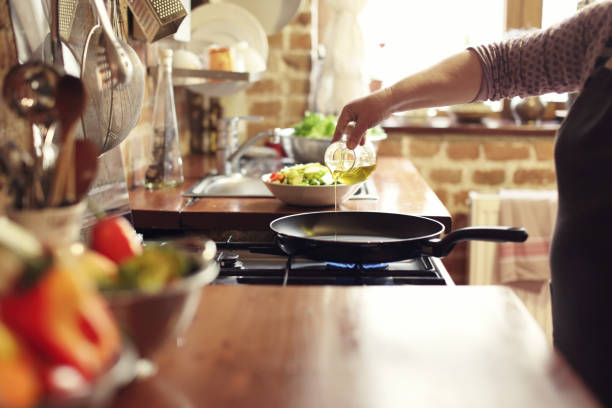 istock Cooking vegetables, step four, pouring the olive oil 921956902