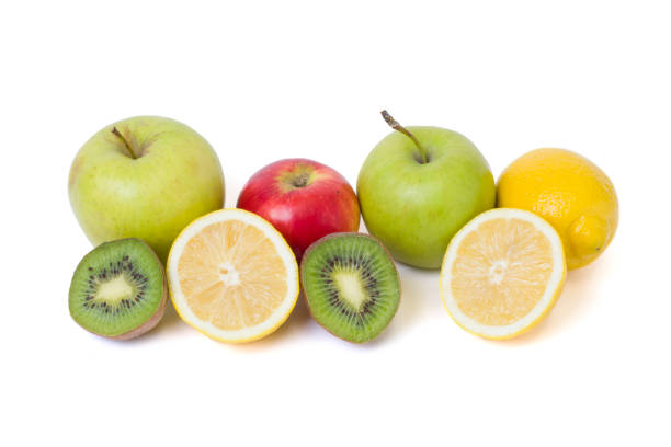 istock Fruits in a composition on a white background. Lemon with apples and kiwi on white background. Fruits with carrots on a white background. 921957334