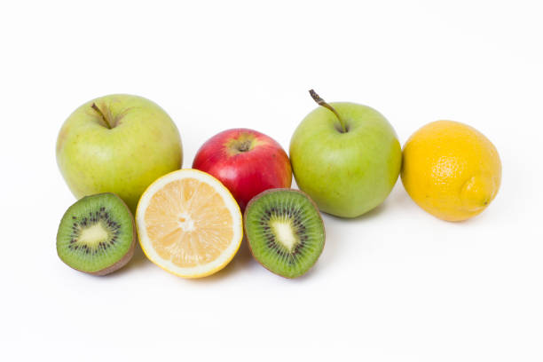 istock Fruits in a composition on a white background. Lemon with apples and kiwi on white background. Fruits with carrots on a white background. 921957336
