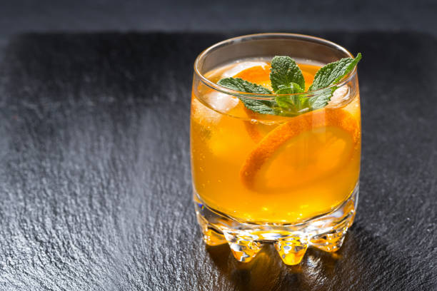 istock orange lemonade with ice in a glass 921957346