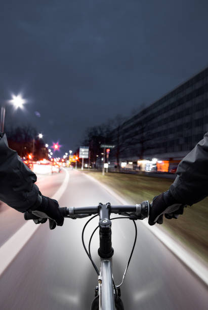 cyclist drives on the bike path past the traffic jam - traffic jam traffic germany car imagens e fotografias de stock