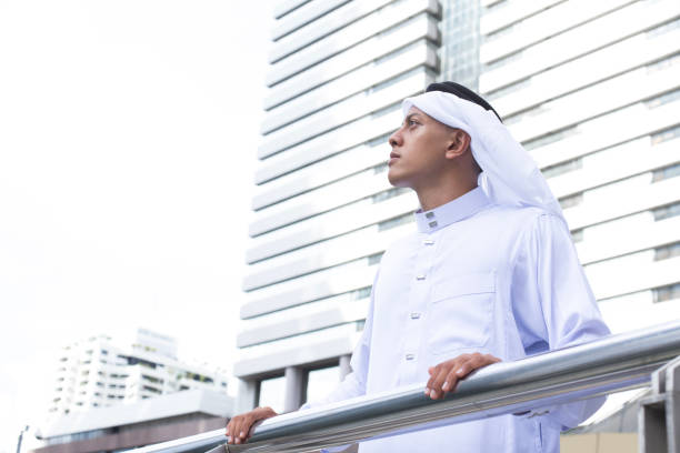istock Arab young man looking to The City. 921966262