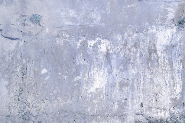 istock Gray concrete wall with cracks and holes. Background with texture. 921973692
