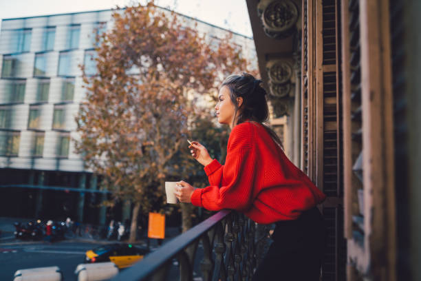 istock Relaxed woman smoking at the terrace 921973734