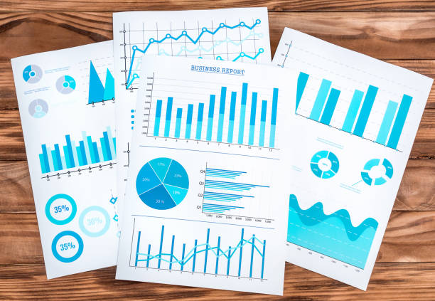 Paper graphs with financial information on the desk. Business workplace. stock photo