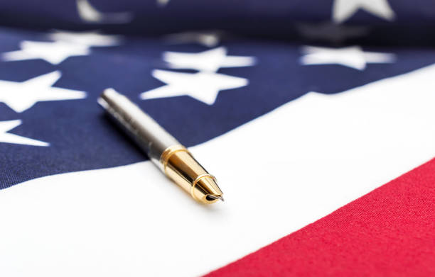Pen on american flag. Close up. Pen on american flag. Close up. independence document agreement contract stock pictures, royalty-free photos & images
