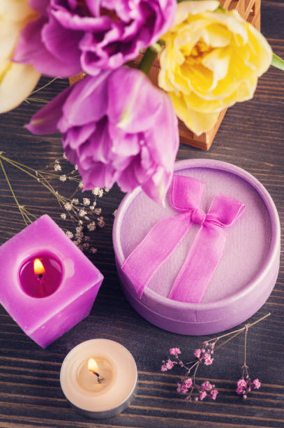 istock Purple yellow tulip flower, lit candles 921980064