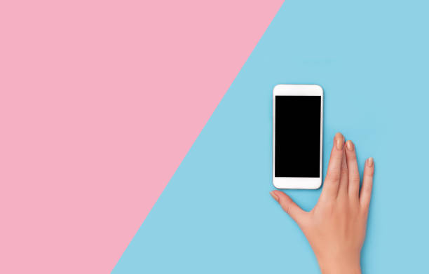 istock hand holding phone on pink background clipping path inside 921980950