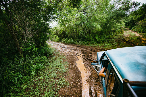 All terrain pick-up truck on muddy dirt road in Mexico