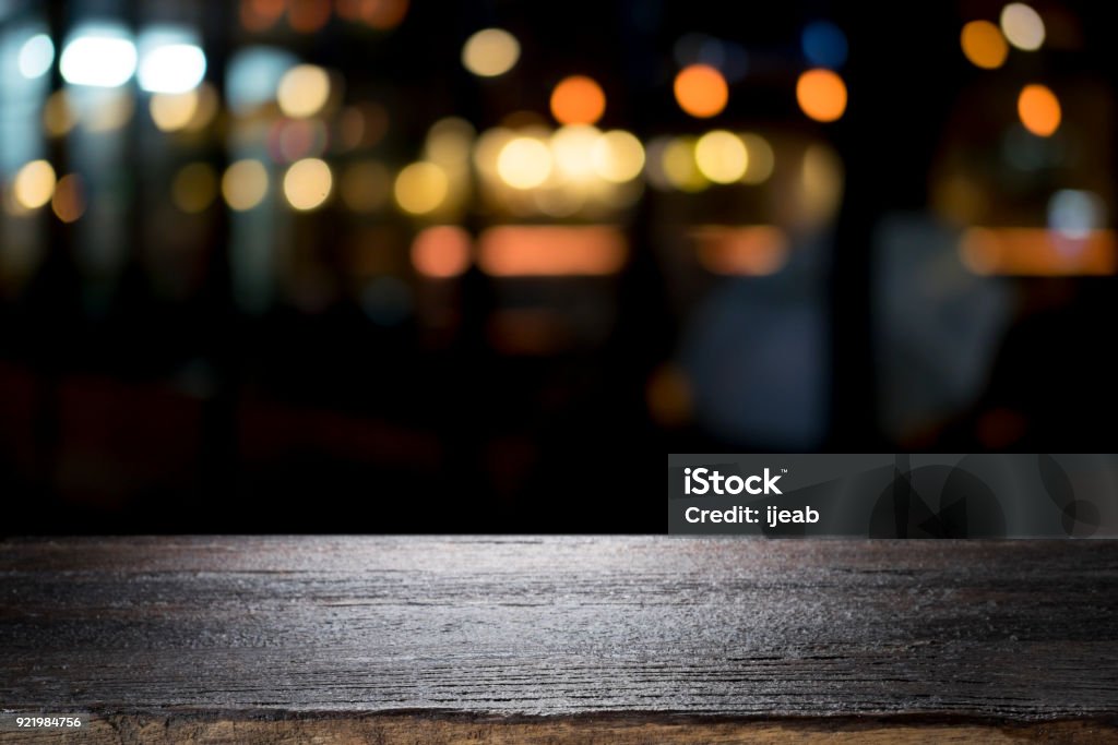 Empty wooden table platform and bokeh at night Backgrounds Stock Photo