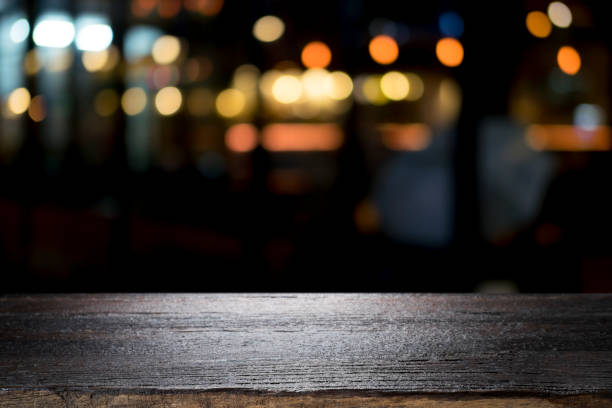 empty wooden table platform and bokeh at night - nobody restaurant empty pub imagens e fotografias de stock