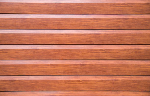 istock New decorative brown wall imitating wooden boards closeup 921987466
