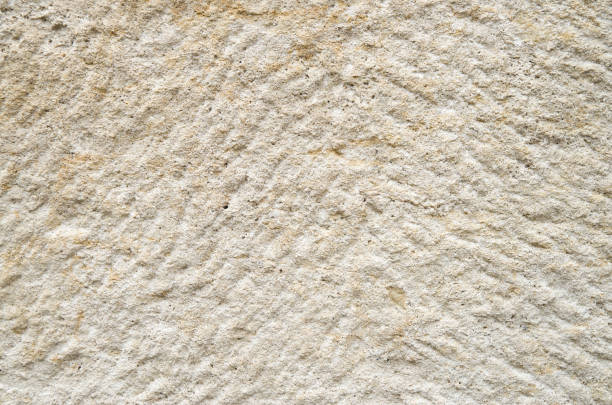 istock Ecru processed limestone closeup in sunny day 921988266