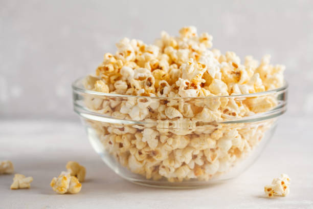 istock Golden caramel popcorn in glass bowl, copy space. 921988282