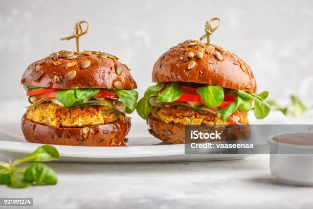 Vegan Lentils Burgers With Vegetables And Curry Sauce On White Dish Healthy Vegan Food Concept Stock Photo - Download Image Now