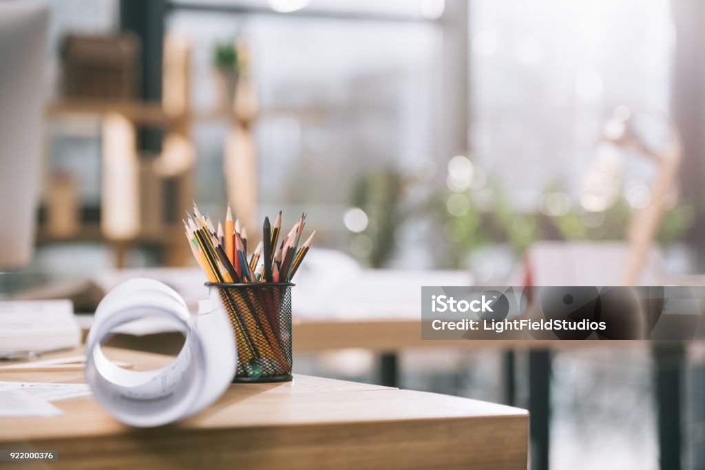 blueprint and pencils on table in modern architect office Office Stock Photo