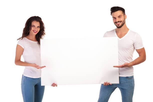 istock young casual couple recommending something on blank board 922001942