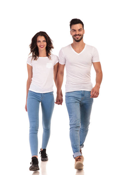 istock smiling young casual couple is walking forward 922006544