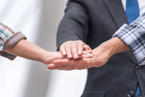 istock businessman and engineering put their hand together, teamwork concept 922006832