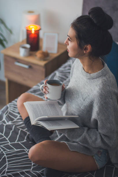 istock Enjoying a good book and coffe in bed 922011194