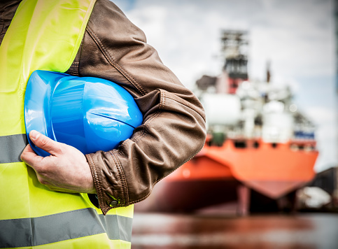 Shipbuilding engineer with safety helmet in shipyard