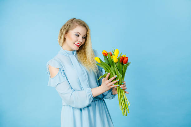 istock Pretty woman with red yellow tulips bunch 922016688