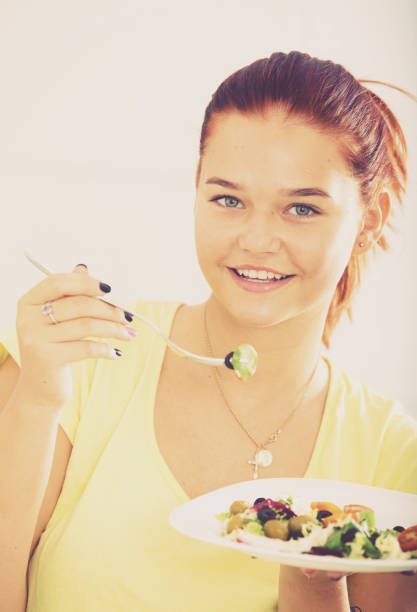 istock girl eating salad 922017948