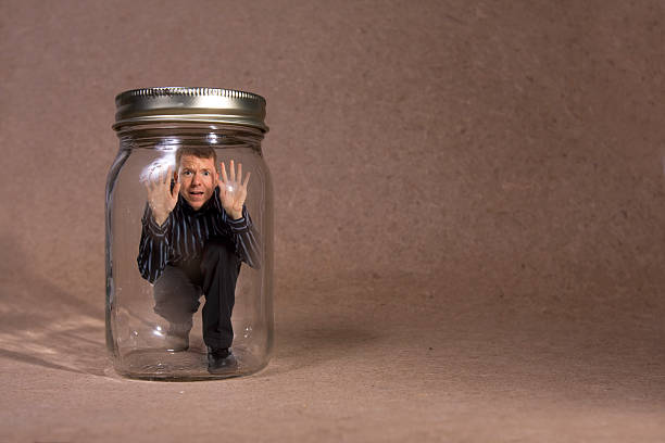 Businessman trapped in jar (Concept Series)  trapped stock pictures, royalty-free photos & images