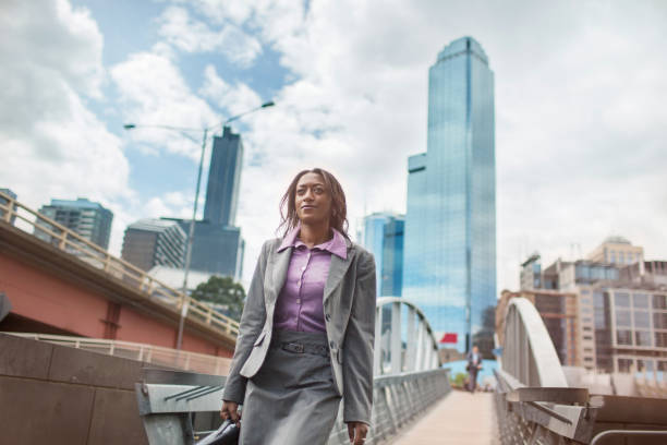 Professional woman walking to work in thoughtful mood