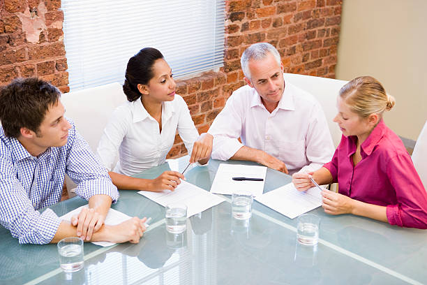 istock Four businesspeople in boardroom talking 92202428